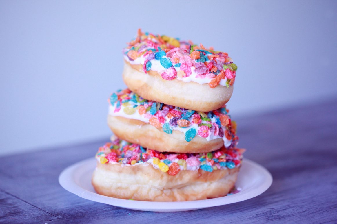 Three Stacked Doughnuts with Colorful Sprinkles